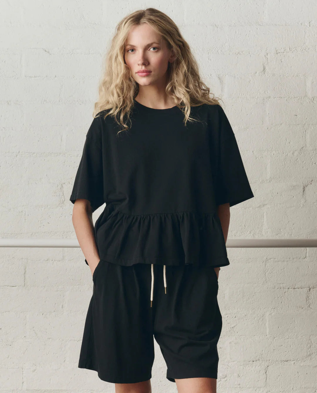 The Oversized Ruffle Peplum Tee. True Black