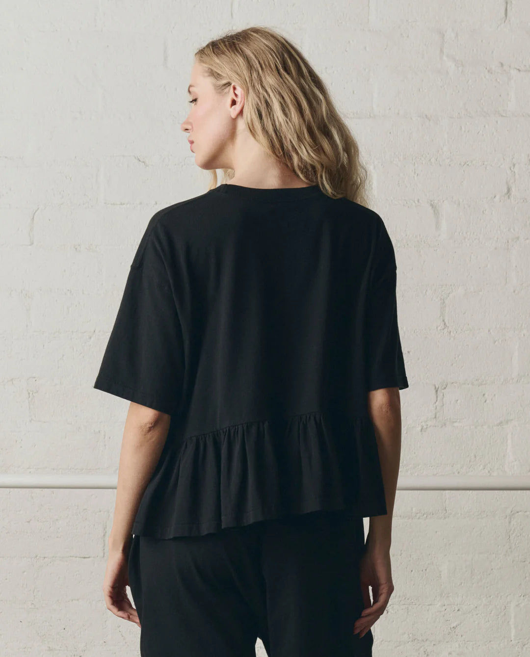 The Oversized Ruffle Peplum Tee. True Black